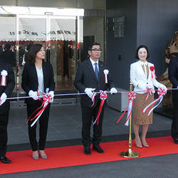 竣工式でテープカットする山田社長（中央）